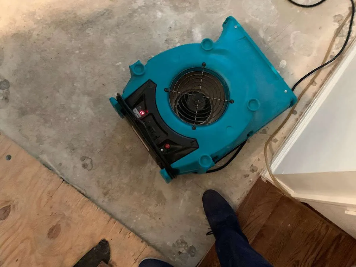 Air mover drying subfloor during Leak Detection & Repair in Oxford